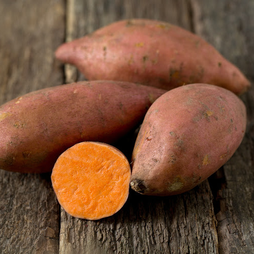 sweet potatoes on a wooden surface